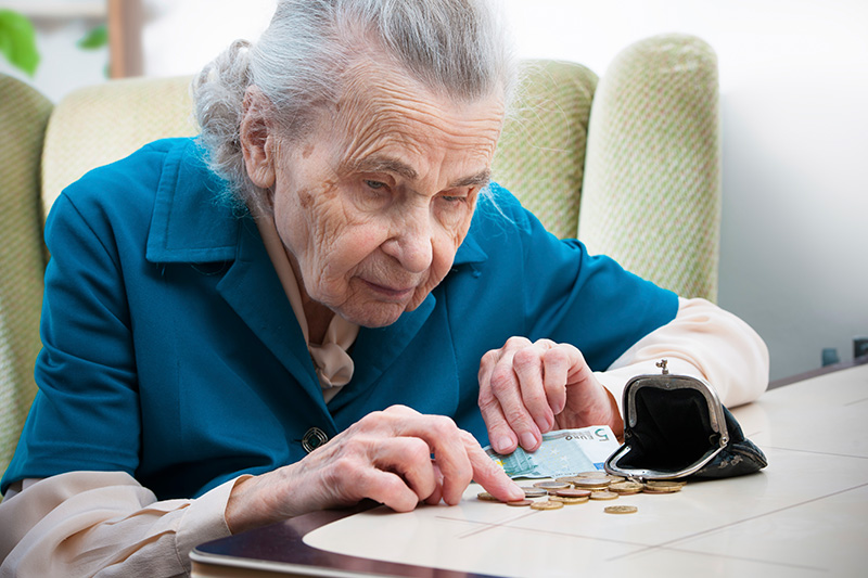 Older woman counting change from her wallet