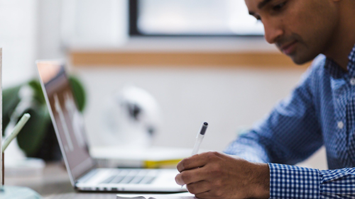 man using laptop for reasearch