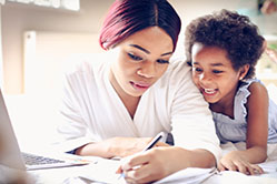 woman and child looking at a form