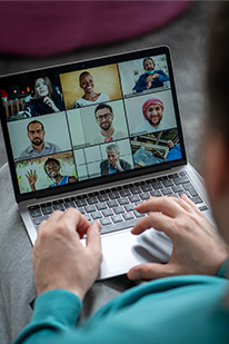 laptop on lap with meeting