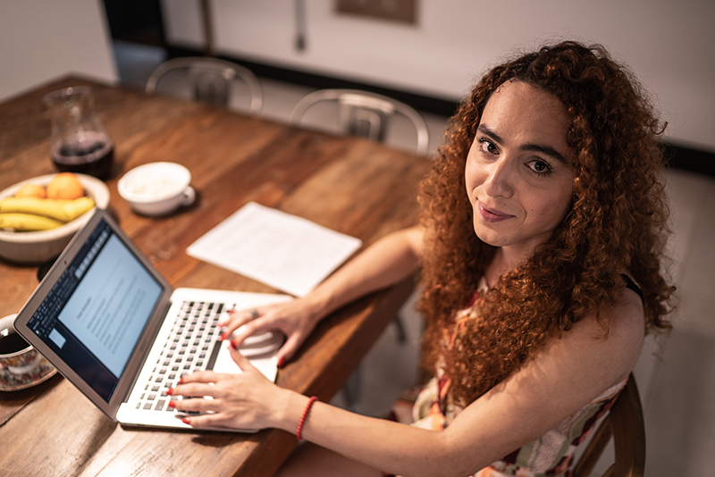 woman sitting at computer looking at camera