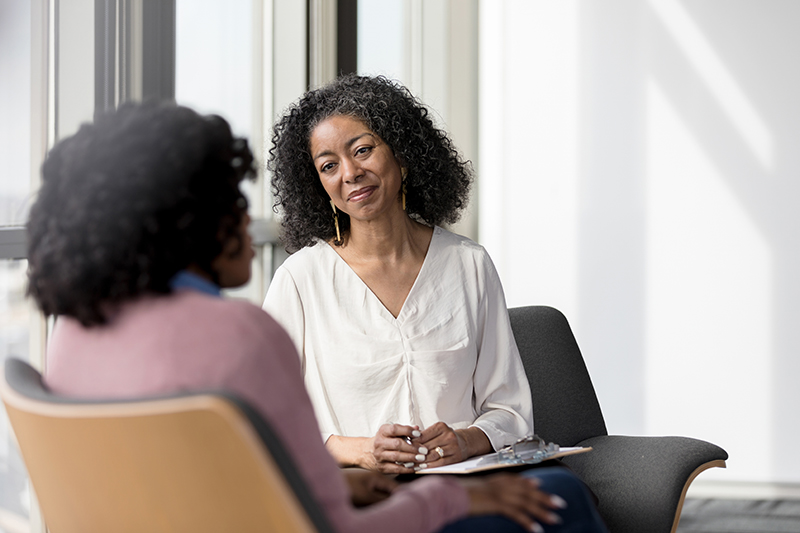 two women sitting and talking