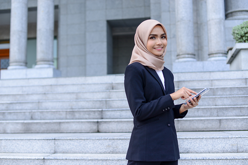 woman looking at the camera standing in front of steps