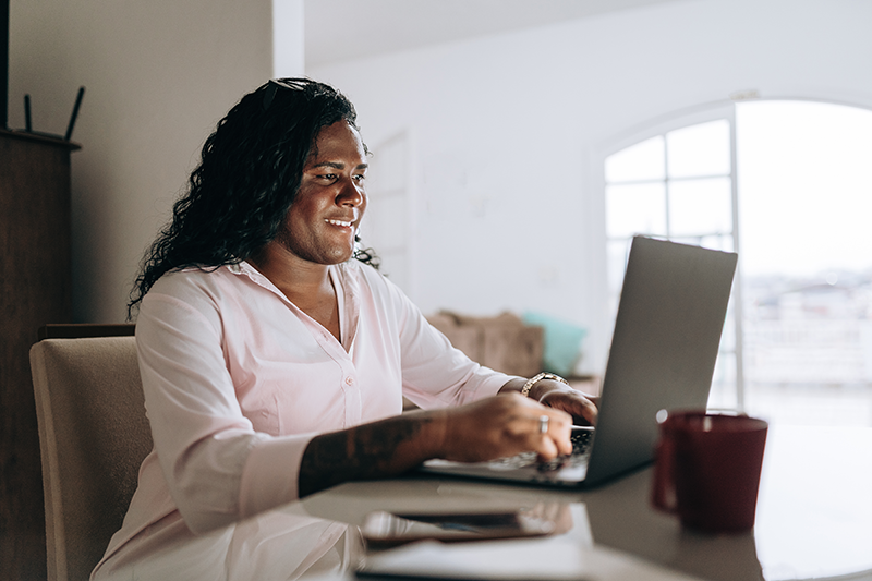 woman sitting at desk typing on computer