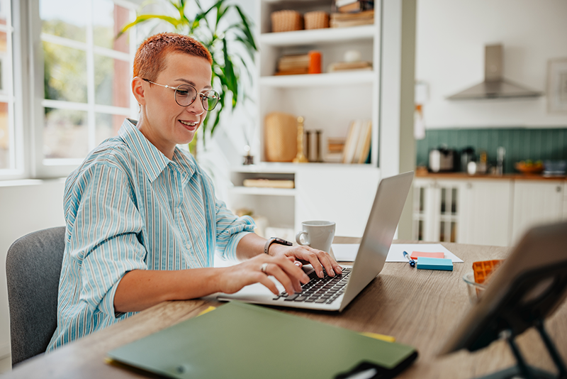 person sitting down typing on a laptop