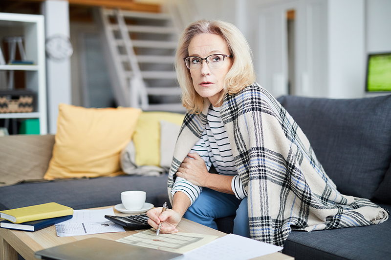 woman sitting at a table with paperwork