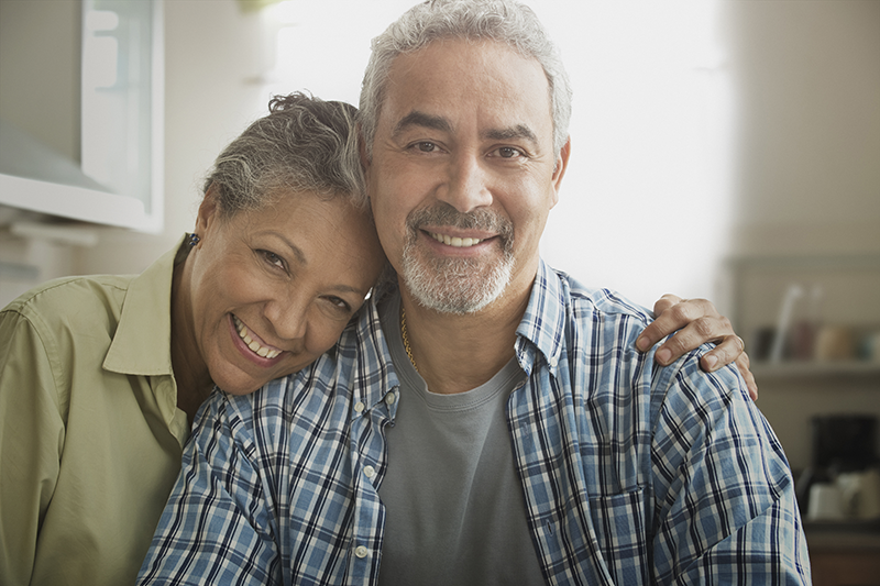 couple hugging looking at camera