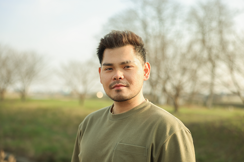 person standing outside looking at camera