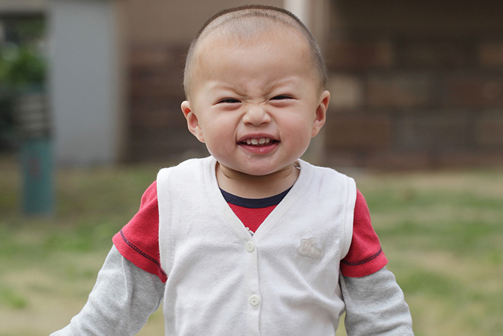 little boy making a face at the camera