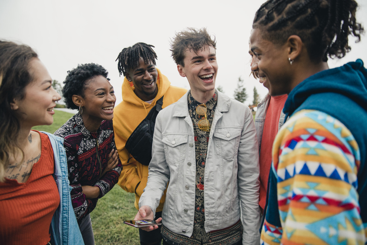 group of teenagers talking and smiling