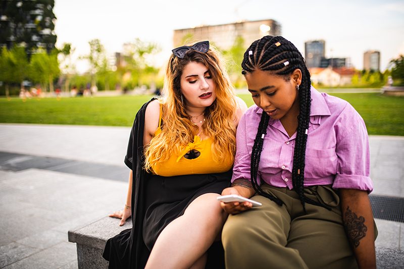 two women sitting down talking