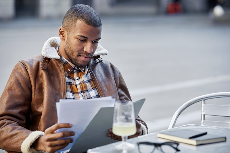 guy sitting down reading papers