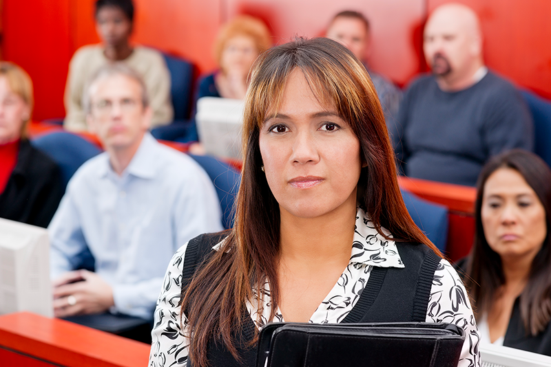 woman in courtroom looking at camera