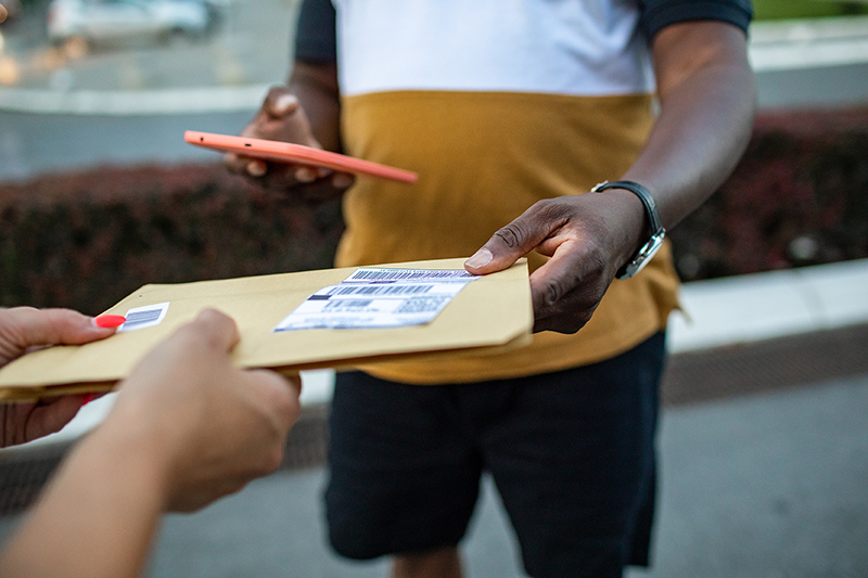 man delivering a large envelope