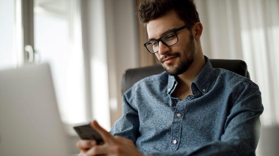 Man with Phone and Laptop