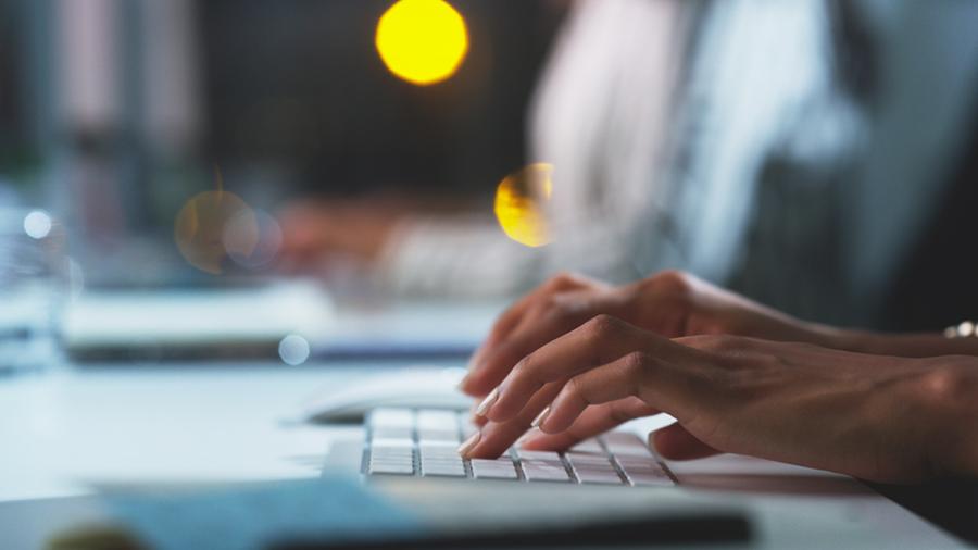 hands typing on keyboard